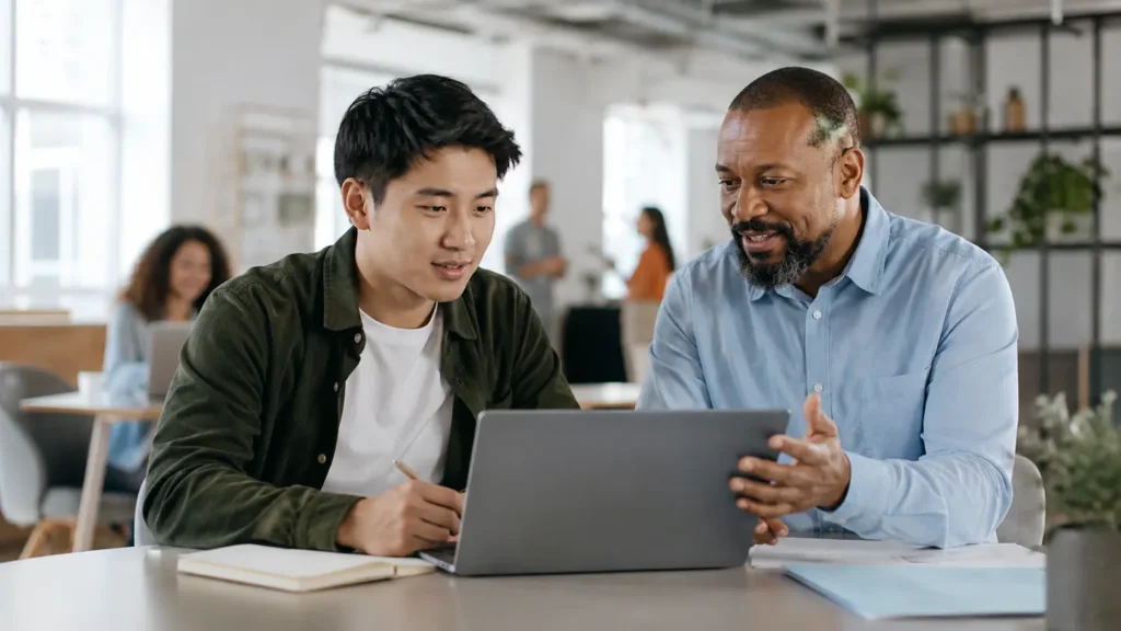 Recent graduate receiving practical feedback from a supportive first-job manager